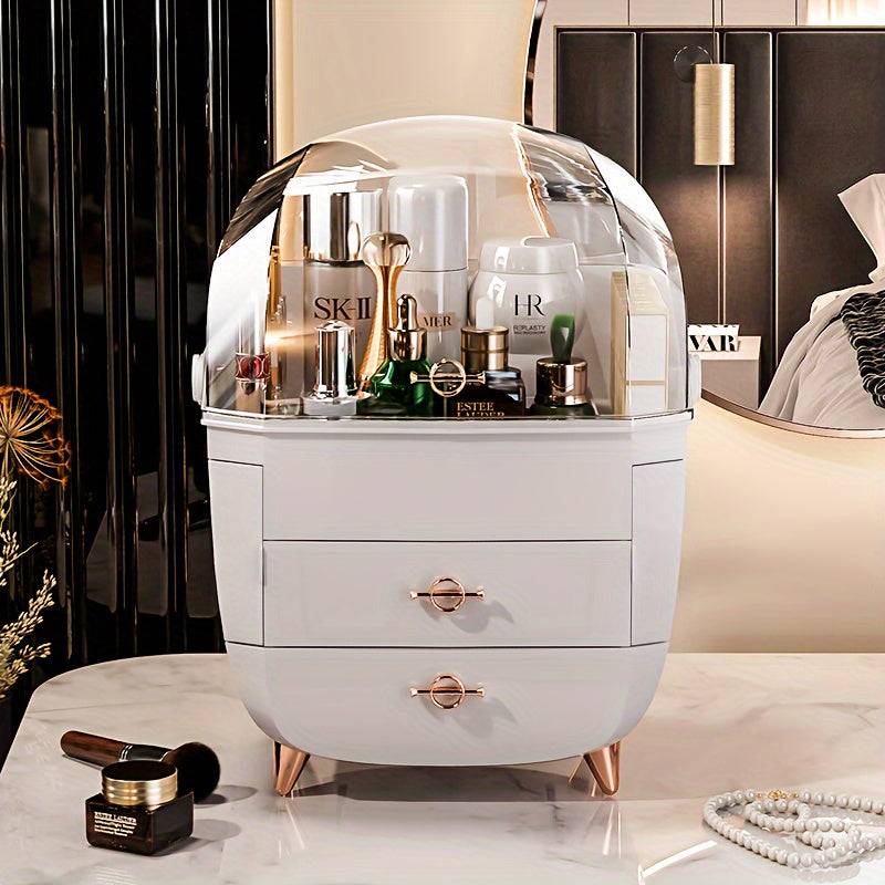 Elegant plastic cosmetic storage box with gold legs and clear dome lid, neatly organizing luxury skincare and makeup products.