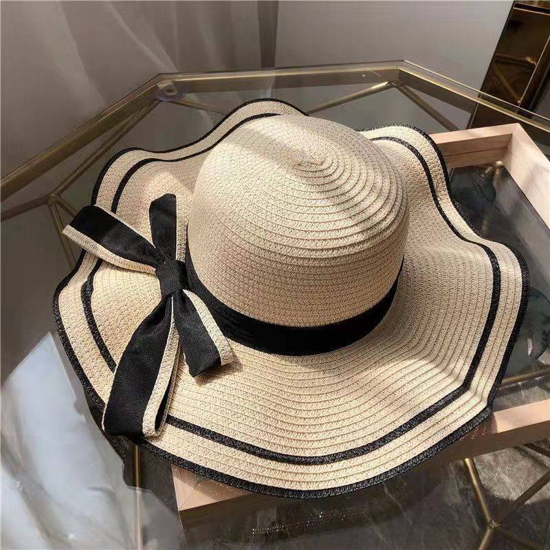 Women's summer beach sun hat with UV protection, wide brim straw-style hat with bow and flower, lightweight for travel
