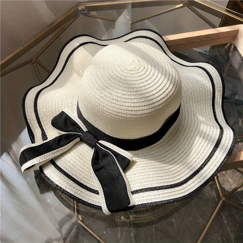 Women's summer beach sun hat with UV protection, wide brim straw-style hat with bow and flower, lightweight for travel