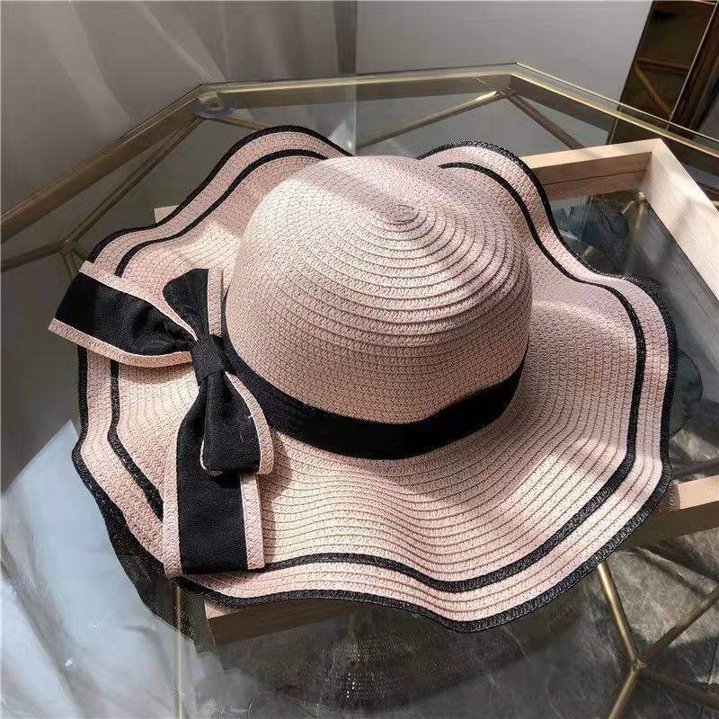 Women's summer beach sun hat with UV protection, wide brim straw-style hat with bow and flower, lightweight for travel