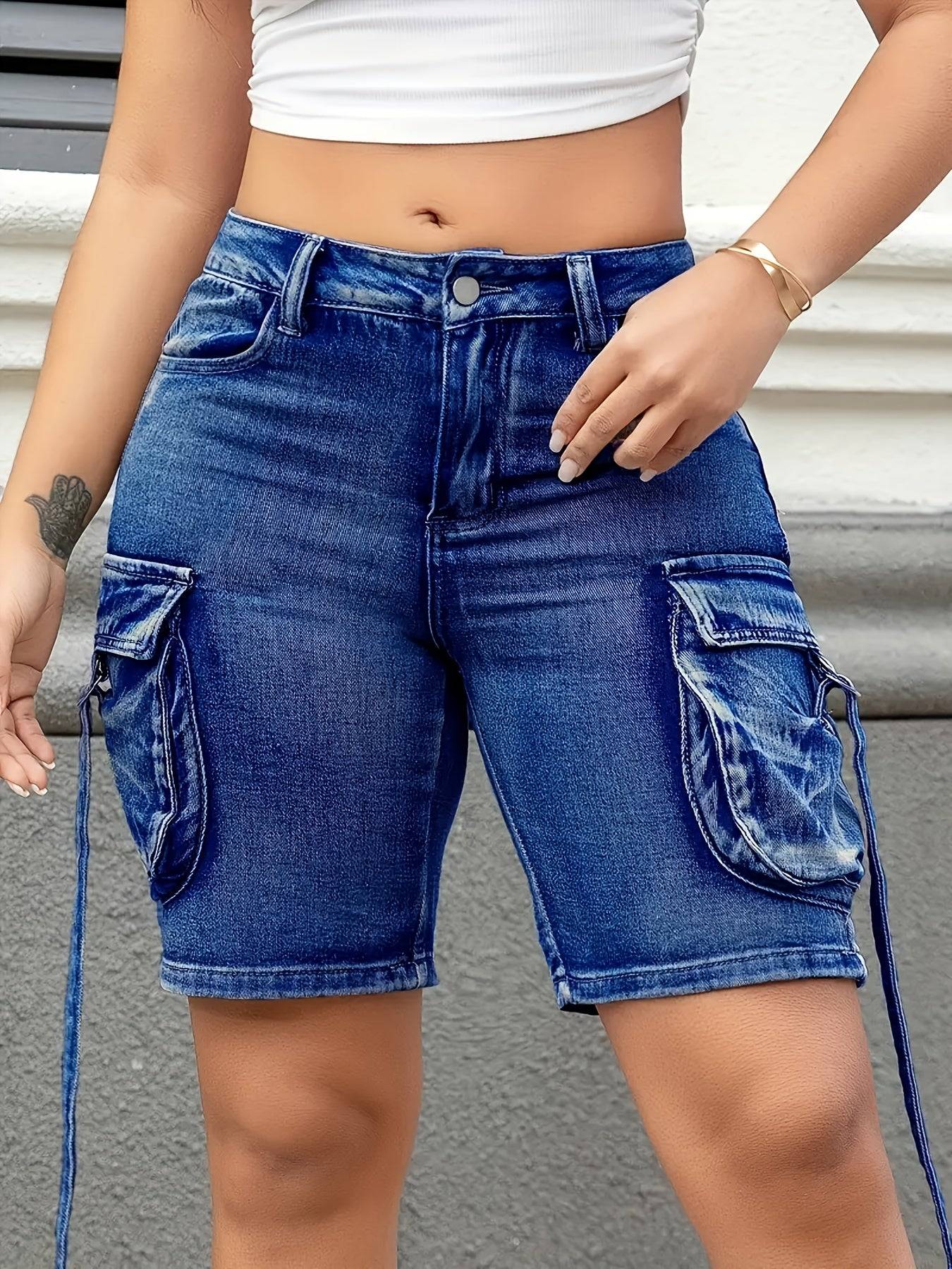 Street style plus size denim shorts featuring low-rise waist, stretch fabric, and large side accordion cargo pockets.