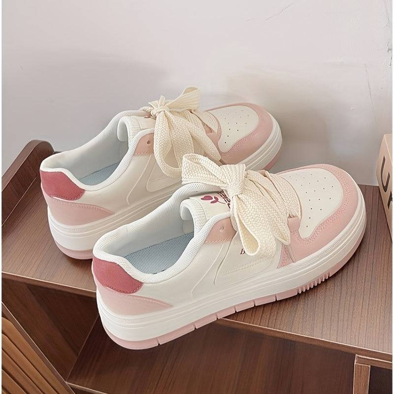 Stylish pink and white women’s sneakers with padded heel and non-slip sole, perfect for casual outings and everyday use.