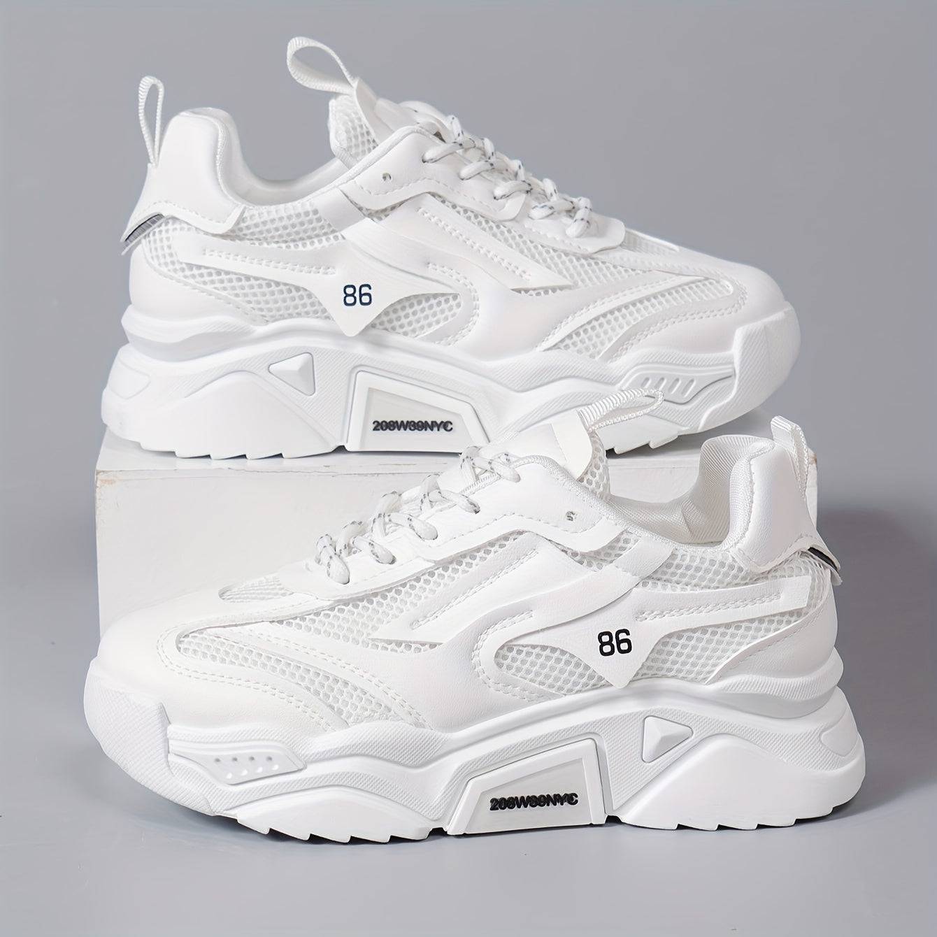 White women’s low-top sneakers with cushioned sole and mesh upper, offering breathable comfort and modern style.