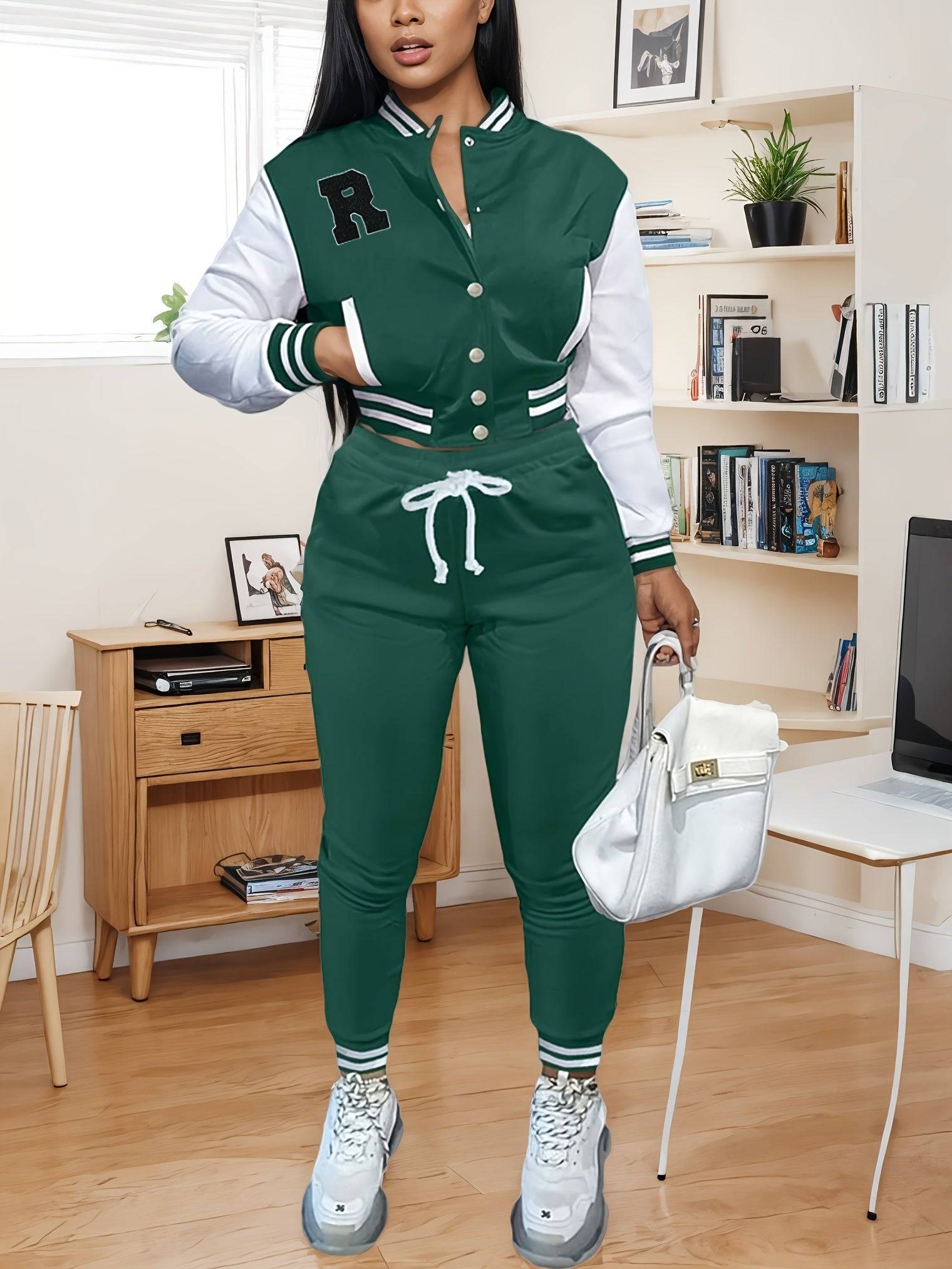 Stylish green women’s 2-piece athletic outfit featuring a buttoned varsity jacket and drawstring pants, perfect for casual or sporty occasions.