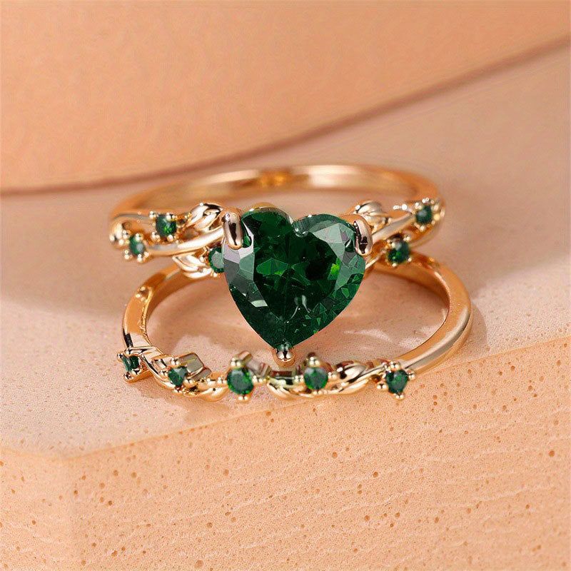 Heart-shaped gold-plated ring set for women featuring green cubic zirconia stones. Includes two vintage-style rings ideal for gifts or daily wear.