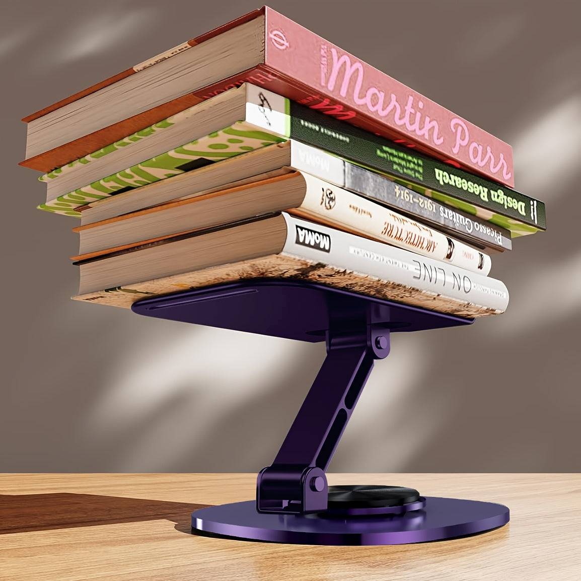 Metal desktop phone stand with 360° rotating base, foldable design, silicone pads, and mechanical click