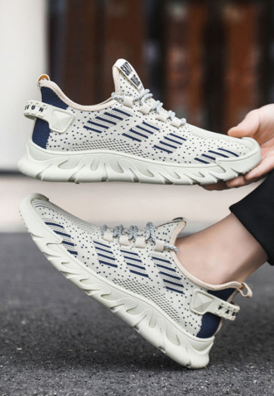 Men's soft sole running sneakers in beige and navy shown in motion, highlighting their lightweight and flexible design for active wear.