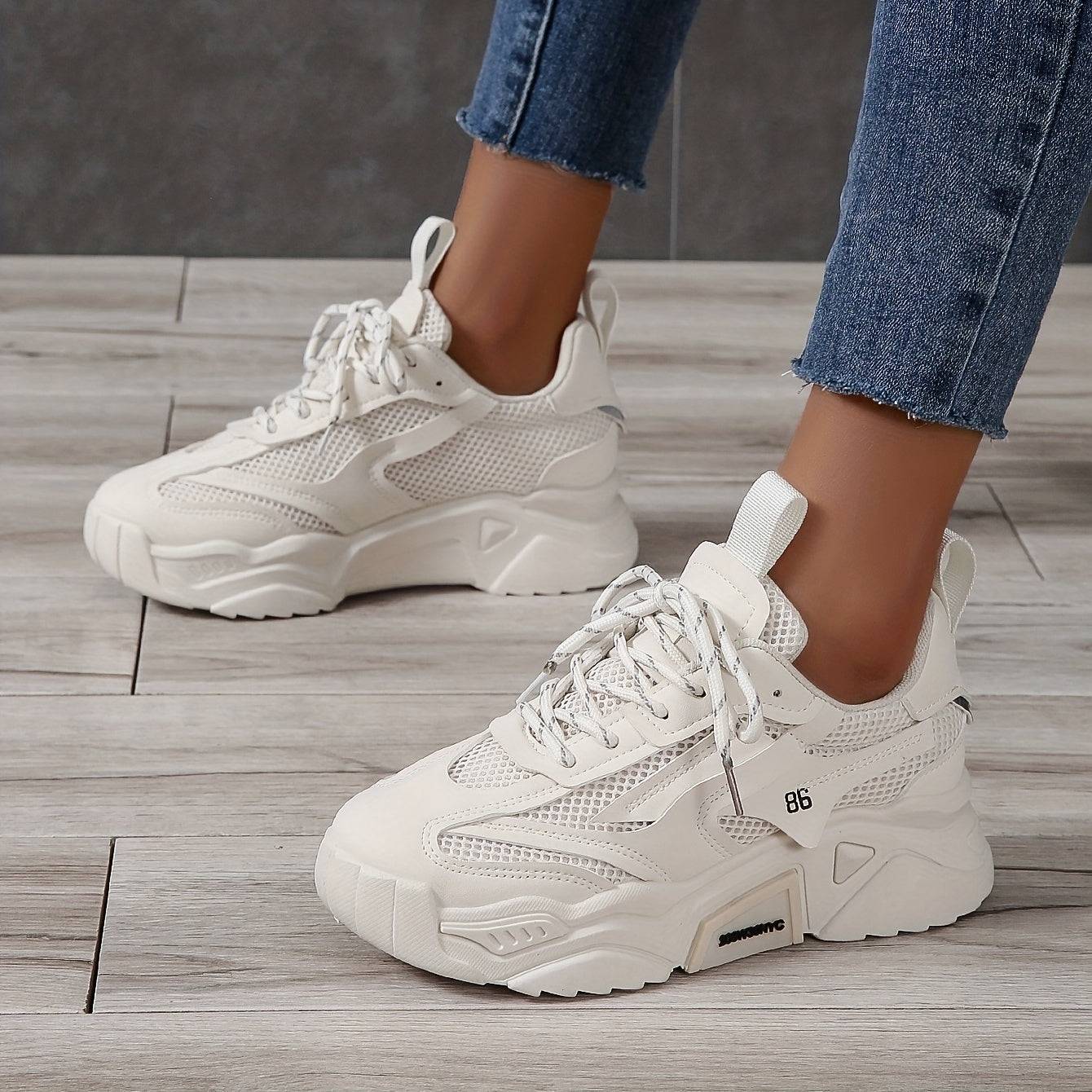 Cream-colored women’s low-top sneakers with cushioned sole and lace-up design, versatile for everyday and office wear.