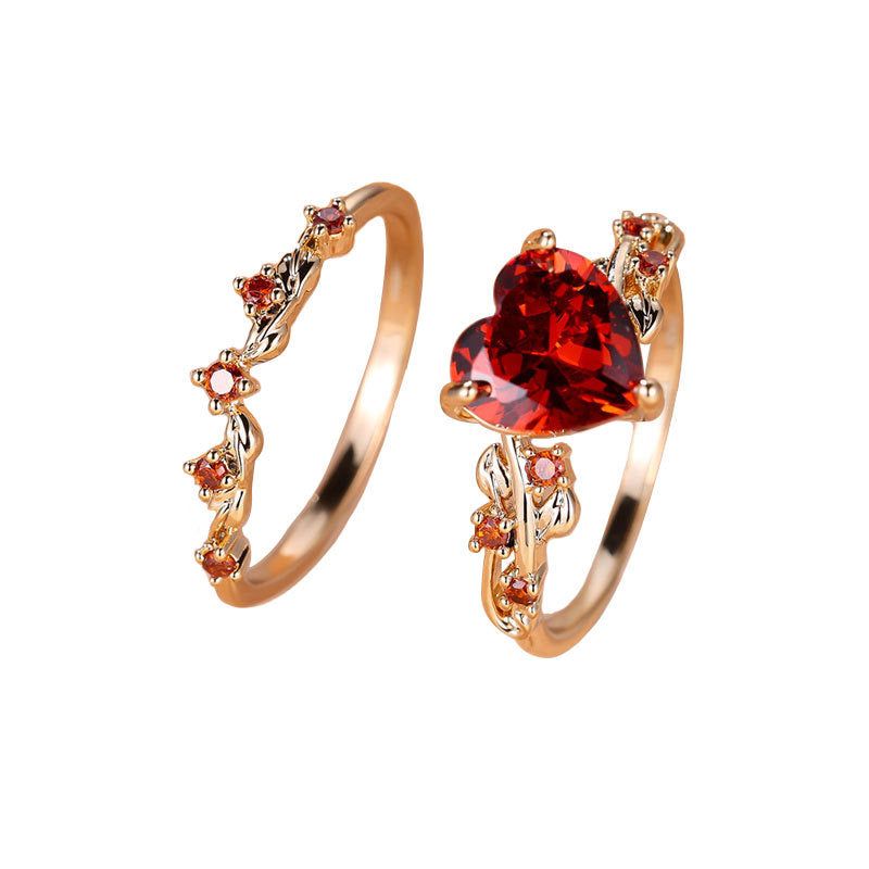 Heart-shaped gold-plated ring set for women featuring red cubic zirconia stones and floral detailing. Includes 2 vintage-style rings for elegant wear.