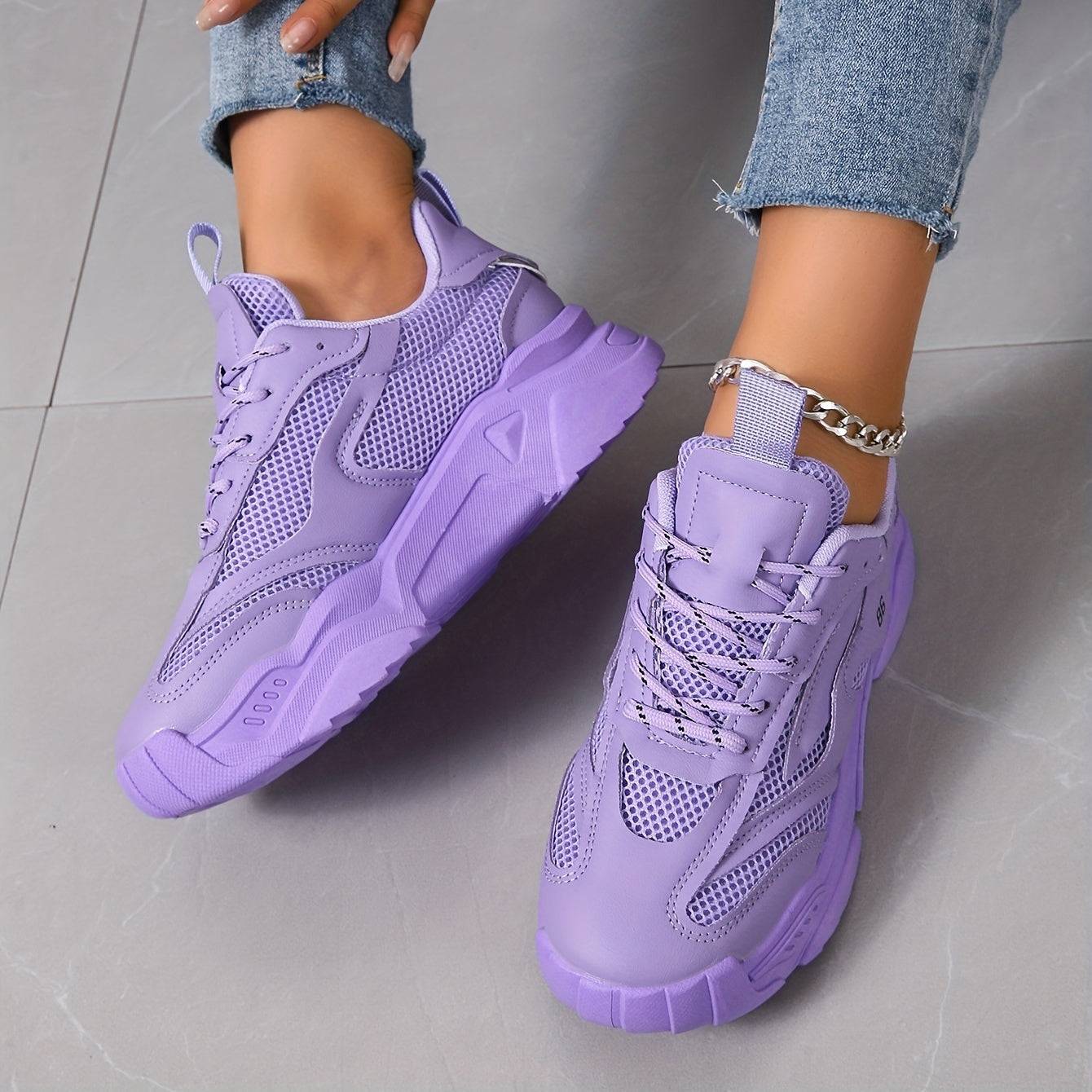 Top view of lavender low-top women’s sneakers with cushioned sole and mesh detailing, perfect for casual and office outfits.