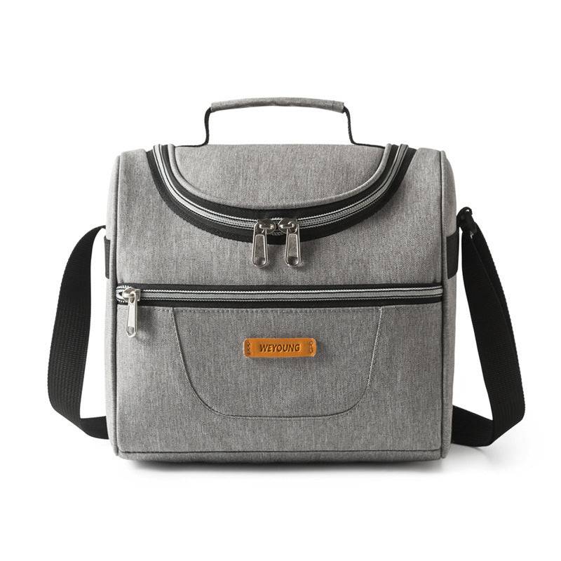 Light grey insulated lunch bag with ice pack and front zipper pocket. Portable cooler tote with handle and strap for convenient carrying.