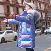 Girl in iridescent winter jacket reaching out arms