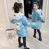 Girl in blue down jacket with bear design, posing in mirror