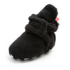 Black fuzzy newborn shoe with soft texture