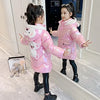 Girl in pink down jacket with bear design, posing in mirror