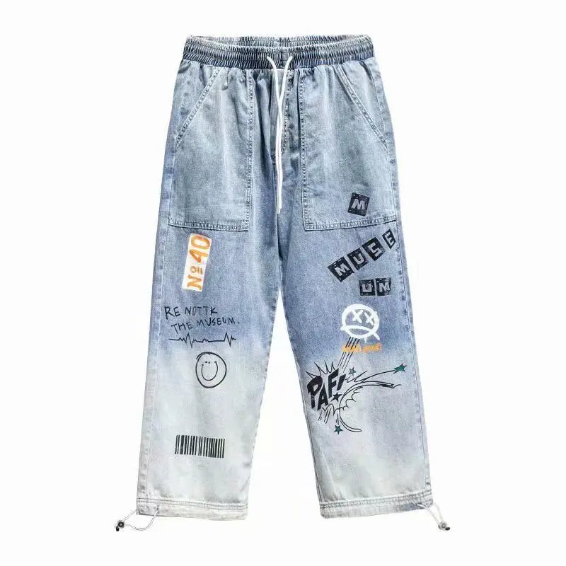 Light blue graffiti-style cargo pants for men, laid flat.