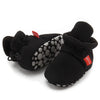 Black newborn shoes with polka dot soles