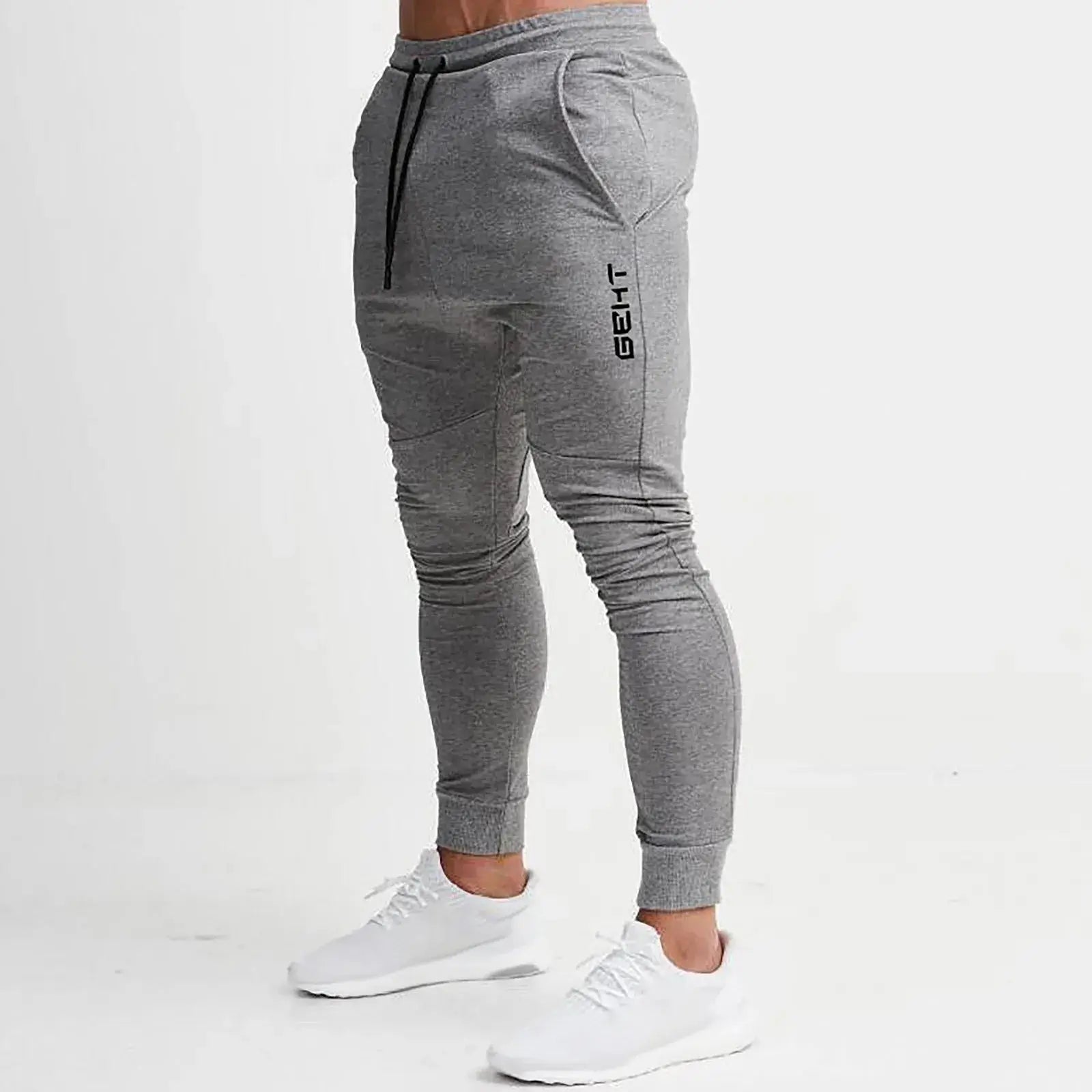 Light gray men’s athletic jogger sweatpants with tapered fit and side pockets, perfect for gym, running, or casual training sessions.