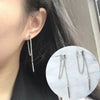 Long tassel earrings with textured metal chain on model