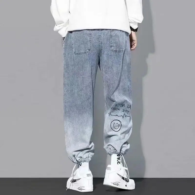 Back view of light blue graffiti-style cargo pants for men.