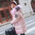 Girl in pink winter jacket with fur collar, holding suitcase