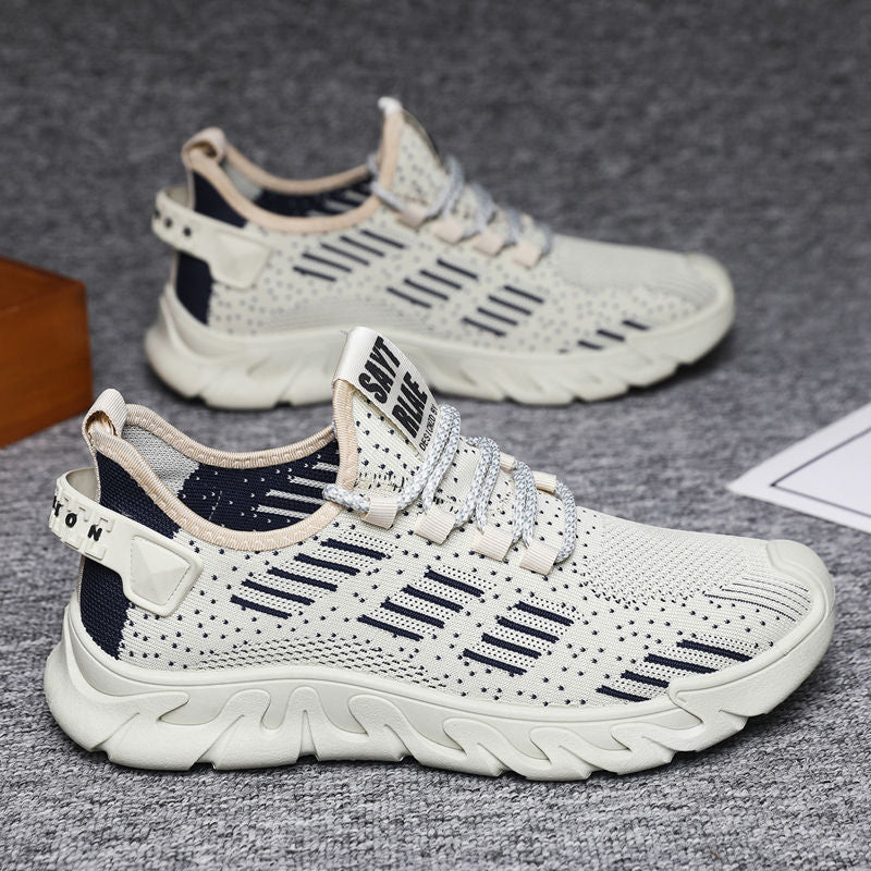 Close-up of men's breathable running sneakers in beige with navy details, designed for lightweight comfort and athletic flexibility.
