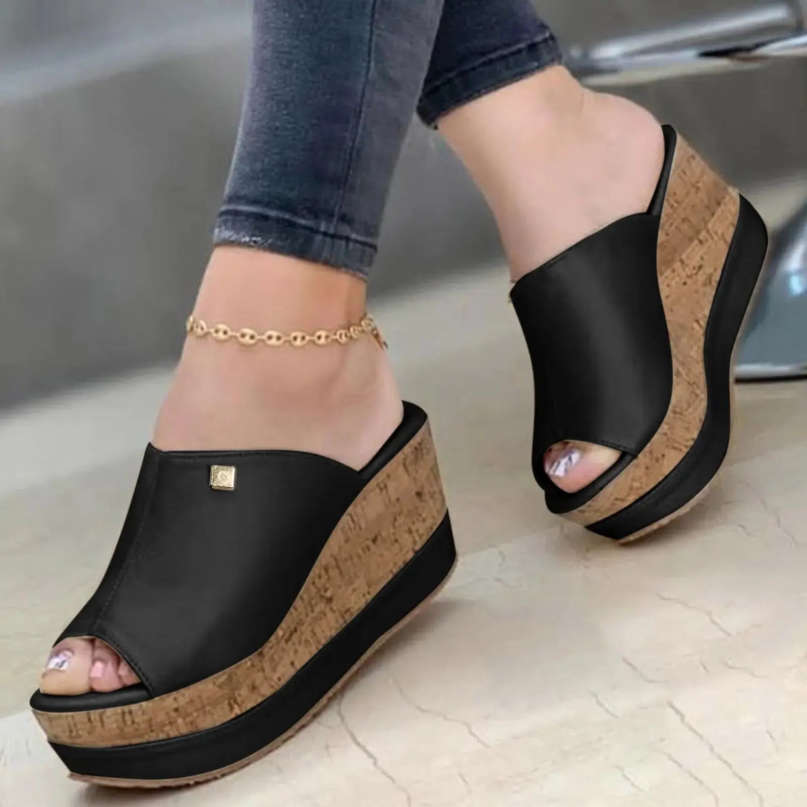 Black Roman-style wedge sandals on model with cork platform, designed for women’s stylish summer daily wear.