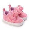 Pink knitted baby shoes with bow