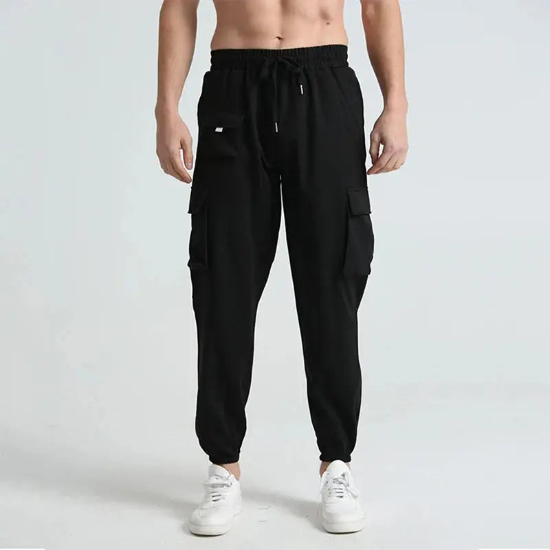 Black men’s lightweight cargo hiking pants with quick-dry fabric, adjustable waistband, and multiple pockets for versatile wear.