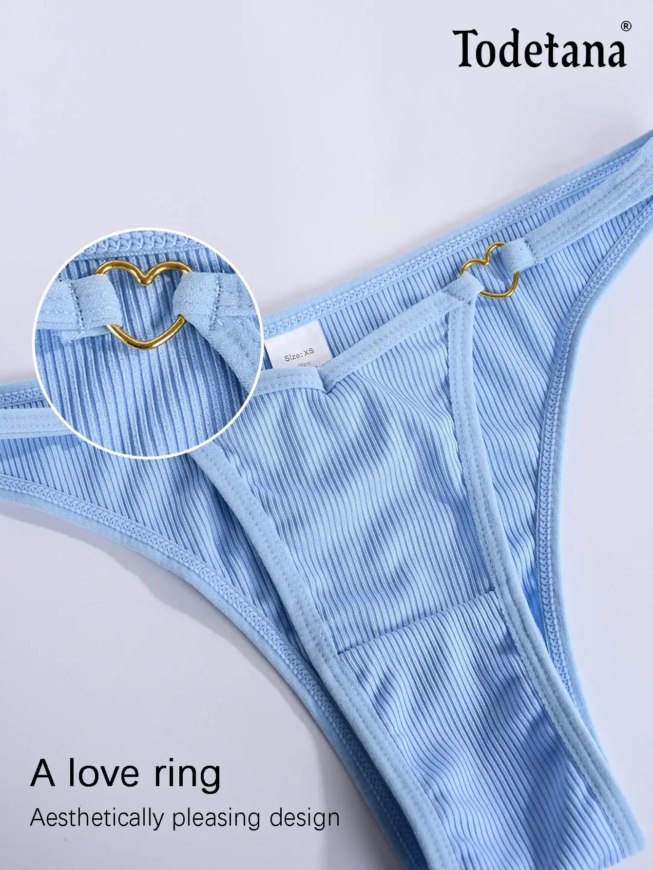 Blue ribbed cotton thong with close-up of gold heart ring detail, part of 7-piece seamless underwear set by Todetana.