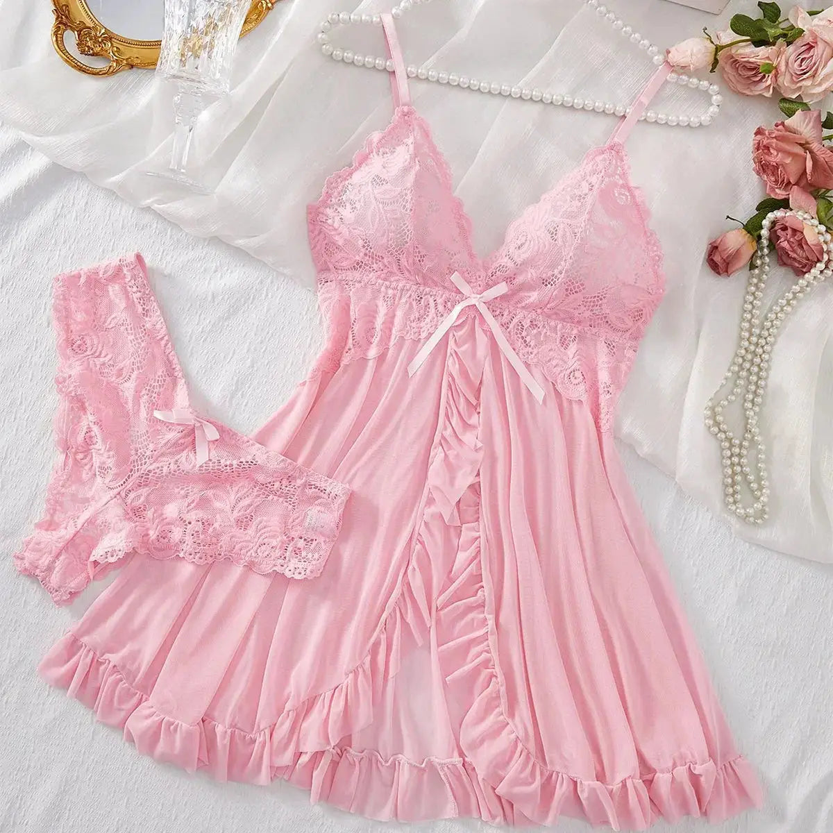 Pink women's lace V-neck sleepwear set with adjustable straps and matching lace panties, ideal for nightwear and loungewear.