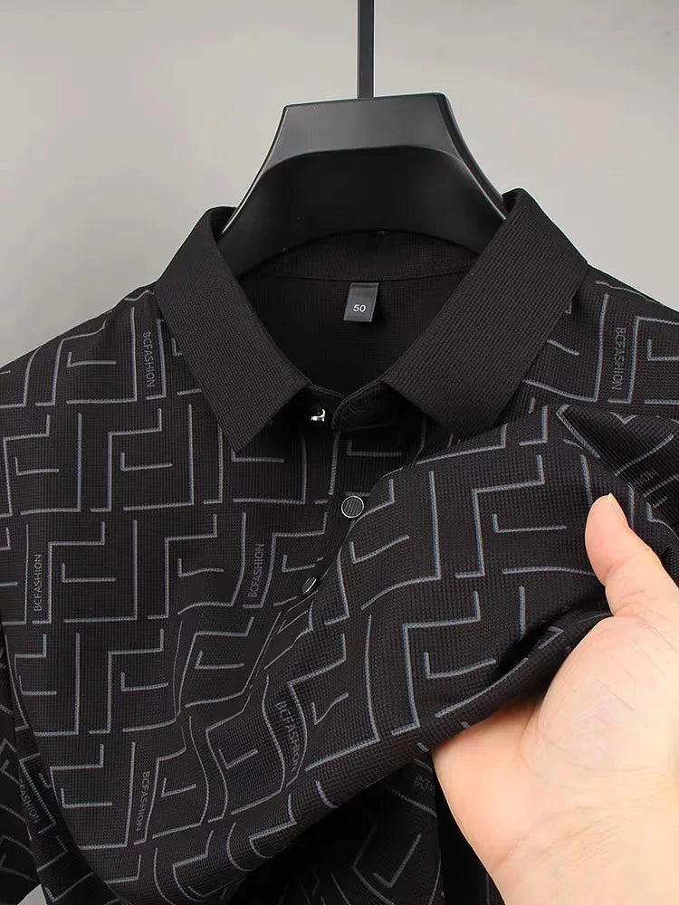 Black silk t-shirt for men with geometric pattern held close-up.