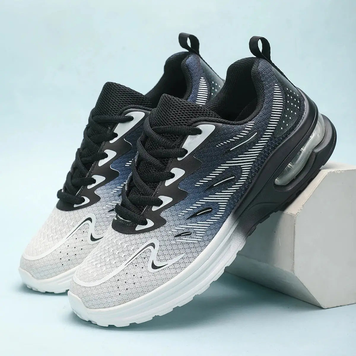 Lightweight women's sneakers in black and white with air-cushioned heel and breathable design for athletic or casual wear.