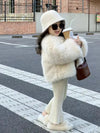 Girl in stylish winter coat, hat, and sunglasses