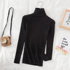 Black women's turtleneck sweater on bed