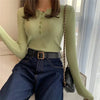 Green knitted women sweater with button decoration.