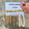 Gold and pearl earring set with geometric designs