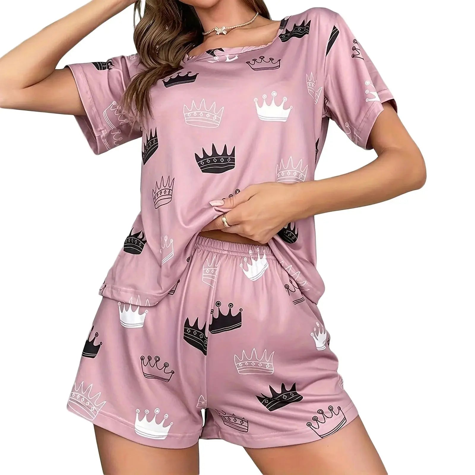 Pink women's 2-piece pajama set with crown print, featuring a short sleeve top and elastic waist shorts for cozy sleep or lounge time.