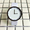 White watch with black minimalist dial