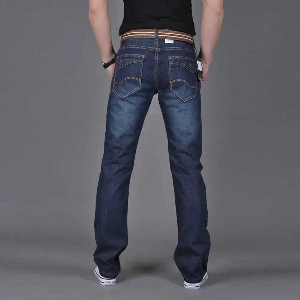 Back view of men’s straight fit stretch denim jeans featuring dual back pockets and a relaxed streetwear silhouette.