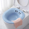 Blue toilet seat Sitz bath with horizontal spray feature.