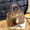 Brown faux leather handbag with pom-pom charms