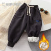 Dark gray thick winter sports pants for kids with fleece lining.