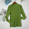 Green women's turtleneck sweater on hanger