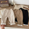 Three pairs of warm winter pants for kids in beige, brown, and black.