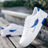 White sneakers with blue feather design