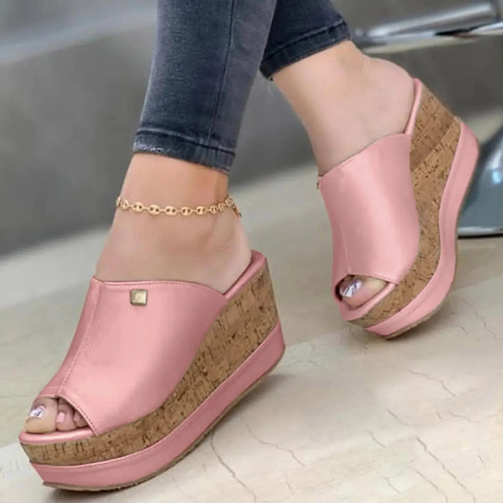 Close-up of pink Roman-style wedge sandals with cork platform, ideal for women’s summer casual and elegant wear.