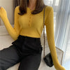 Yellow knitted women sweater with button decoration.