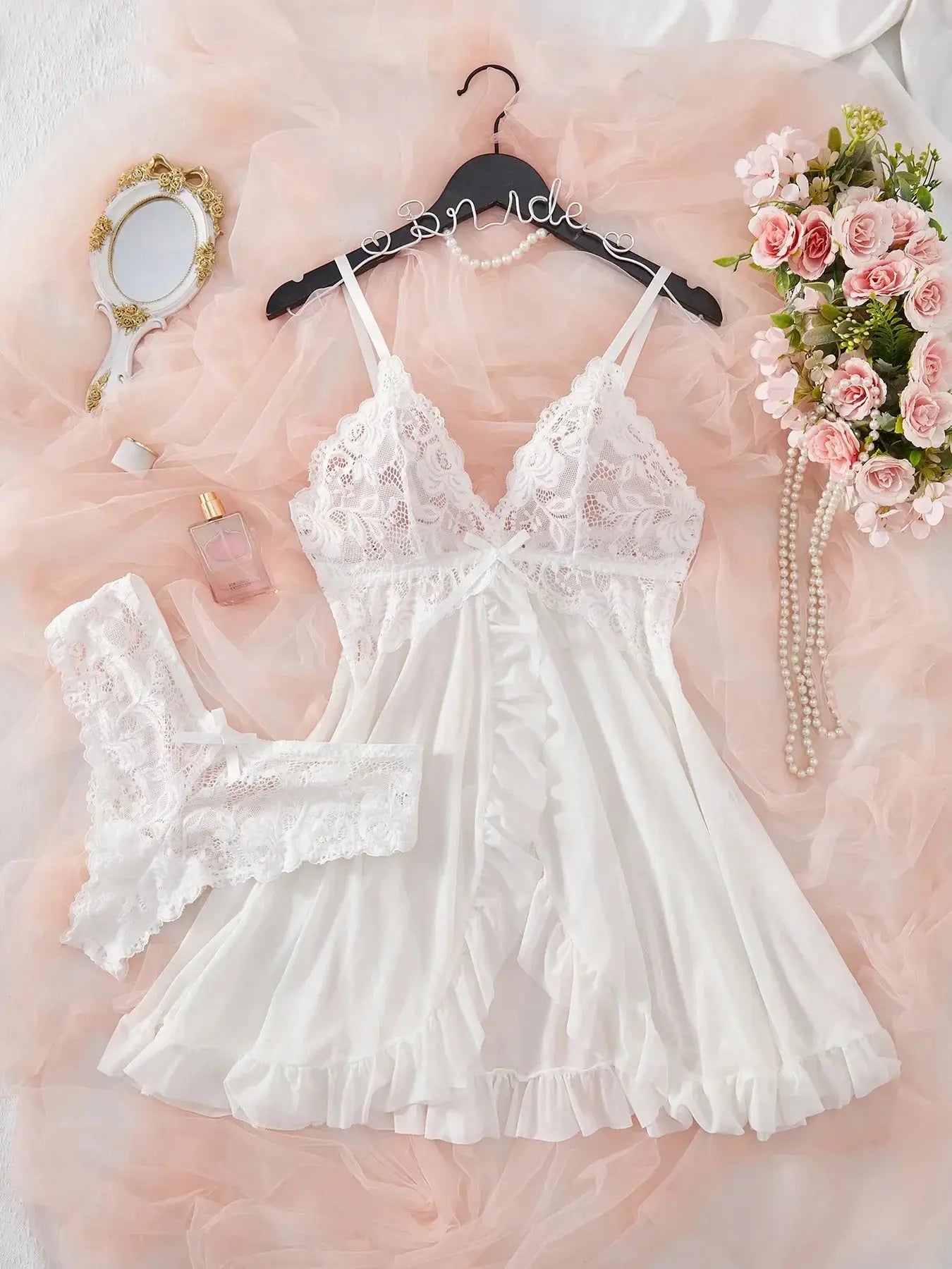 White lace V-neck sleepwear set with ruffled hem and matching lace panties, perfect for bridal or romantic loungewear.