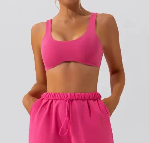 Pink slim fit yoga bra, front view, paired with matching joggers.